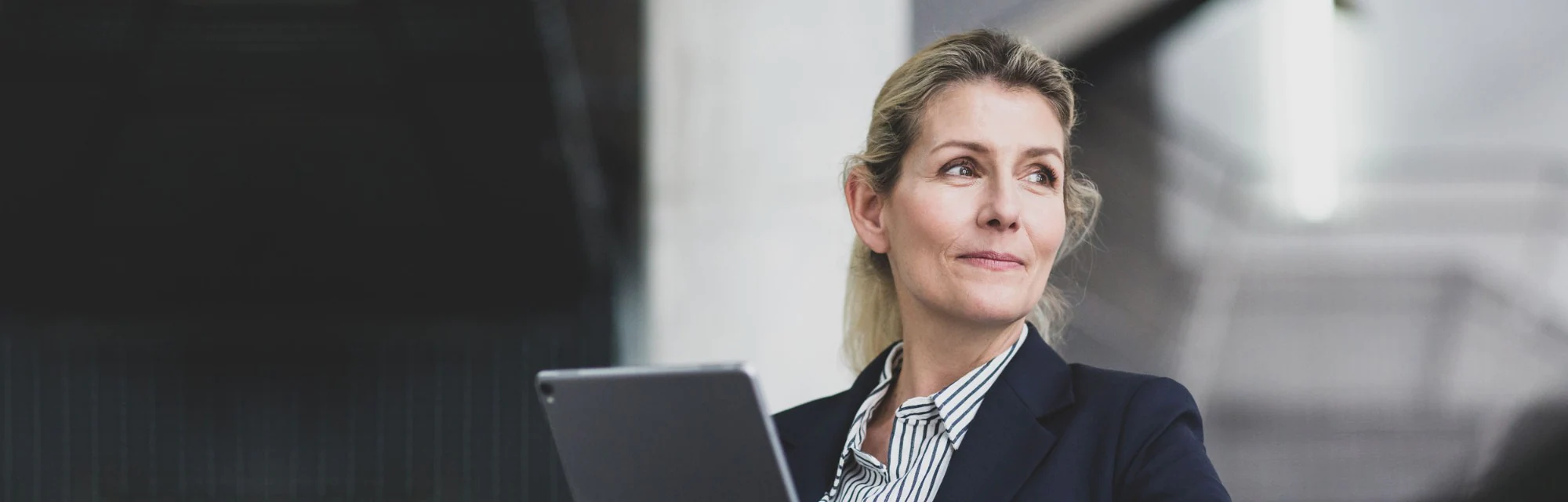 Woman using her tablet to sign on to  New Orion Online Bank SmartBanking for Business